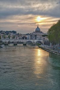 View of bridge over river against cloudy sky