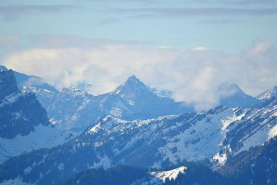 Scenic view of snow covered mountains against sky