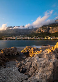 Scenic view of lake and mountains against sky