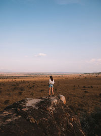 Side view of man standing on rock