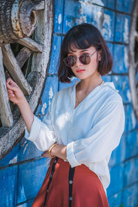 Young woman wearing sunglasses standing outdoors