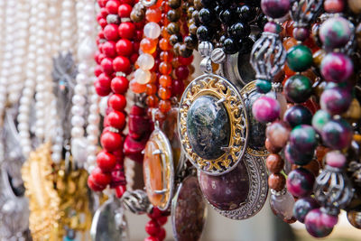 Close-up of necklaces hanging in market for sale