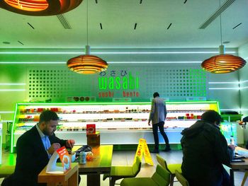 People standing in illuminated restaurant