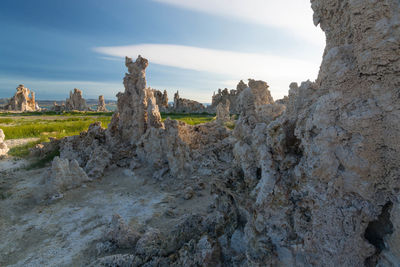 Rock formations on landscape against sky