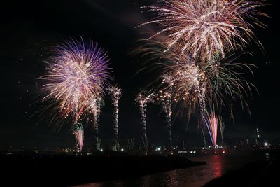 Low angle view of firework display at night