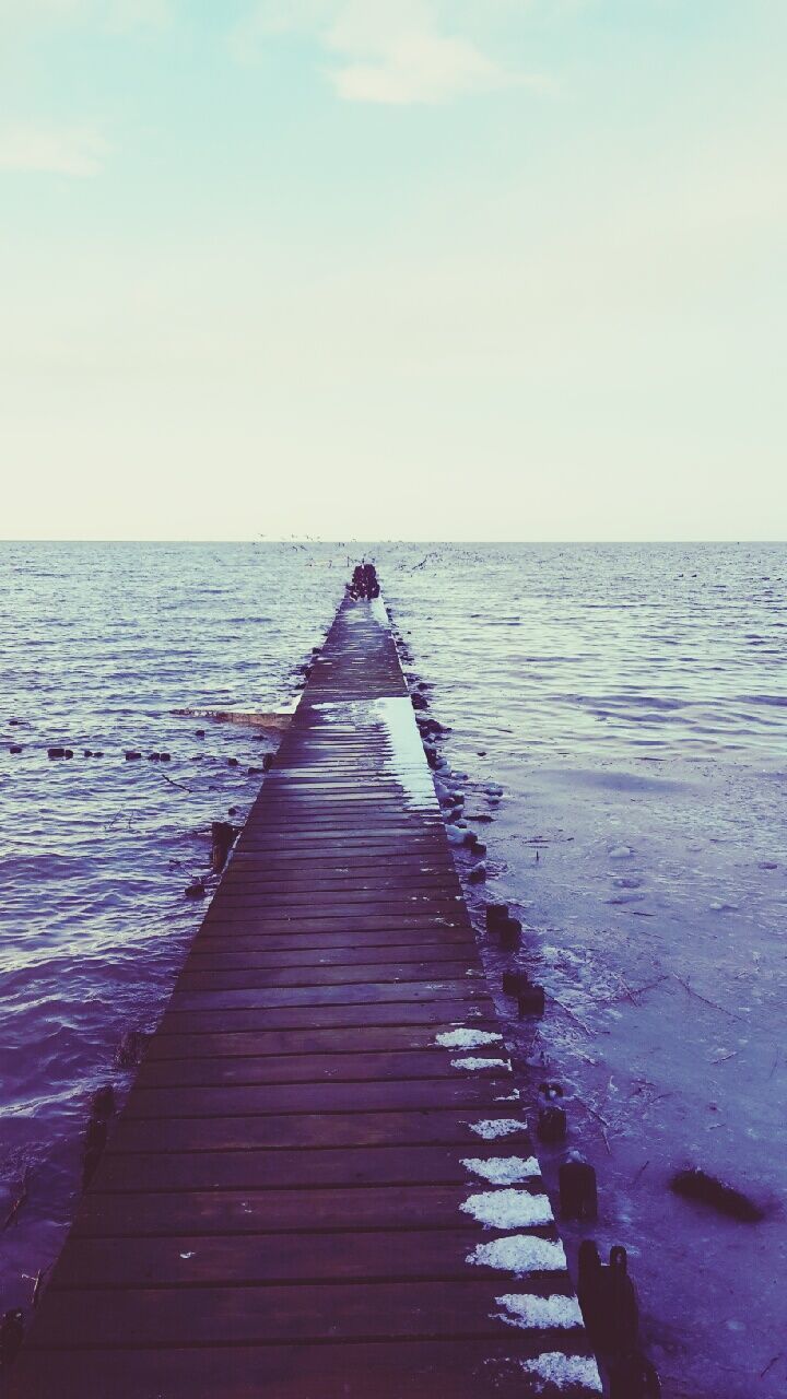 water, sea, horizon over water, pier, the way forward, tranquil scene, tranquility, scenics, jetty, wood - material, sky, beauty in nature, nature, boardwalk, idyllic, rippled, rear view, lifestyles