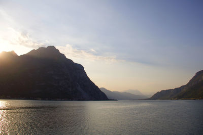 Scenic view of sea and mountains against sky