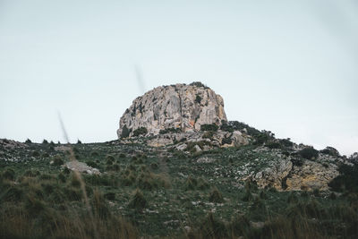 Rock formations on landscape against clear sky