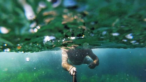 Close-up of man swimming in water