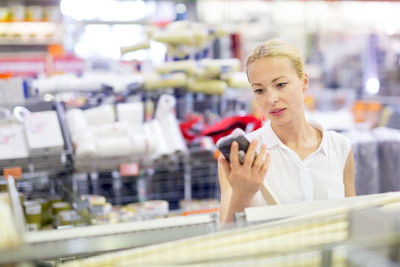 Mid adult woman standing in departmental store