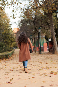 Rear view of girl standing at park