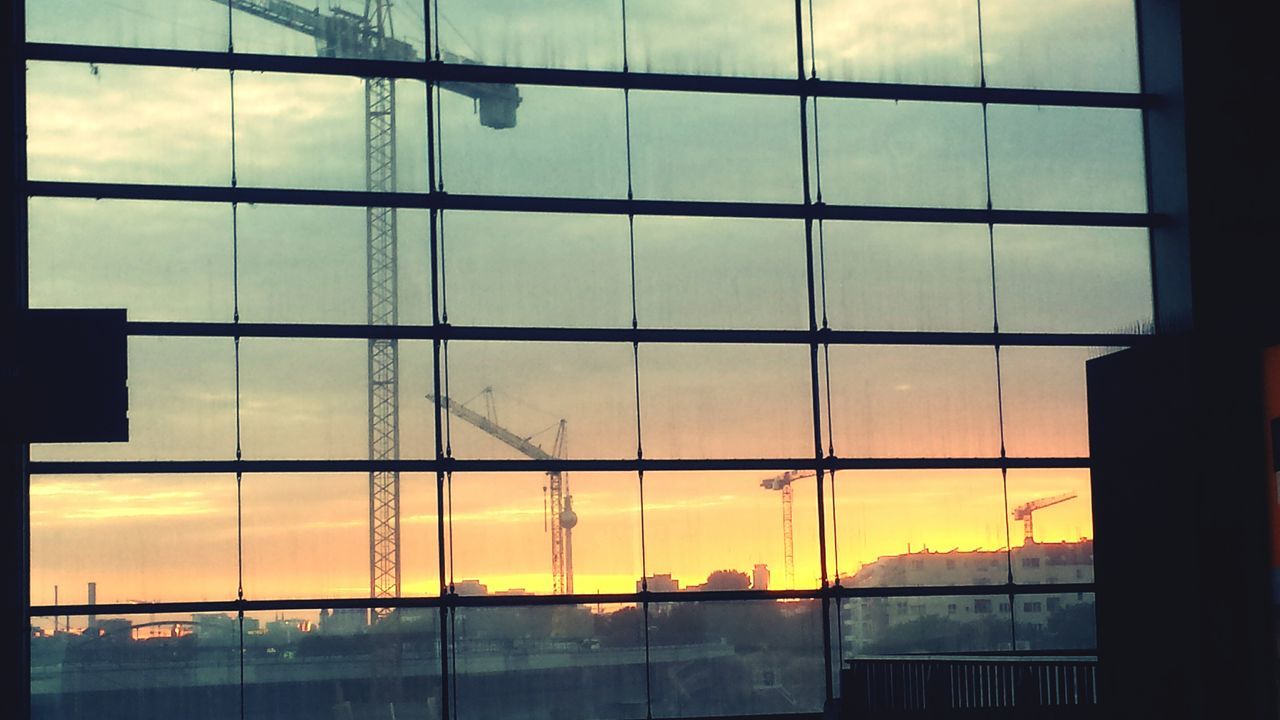 window, indoors, transparent, glass - material, sky, sunset, glass, cloud, cloud - sky, window frame, full frame, orange color, geometric shape, cloudy, no people, urban skyline