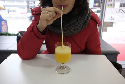 |midsection of woman having drink at restaurant