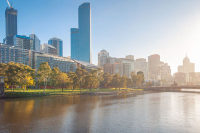 Buildings in city against clear sky