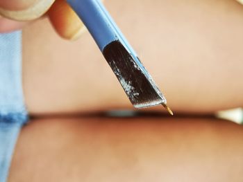 Close-up of person holding umbrella on table