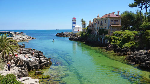 Panoramic view of sea and buildings against clear sky