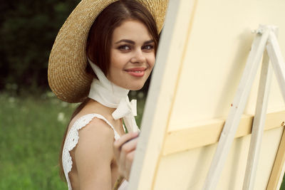 Portrait of young woman wearing hat