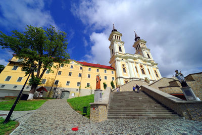 Low angle view of temple amidst buildings against sky