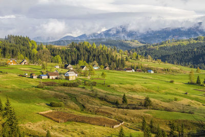 Scenic view of agricultural field and mountains against sky