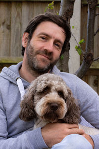 Portrait of man with cockapoo dog