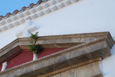 Low angle view of cross on wall of church