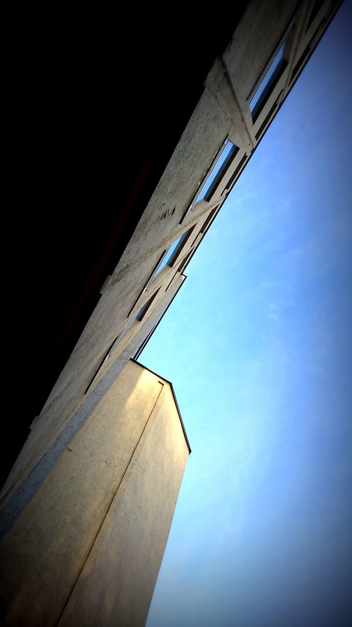 LOW ANGLE VIEW OF BUILDINGS AGAINST BLUE SKY