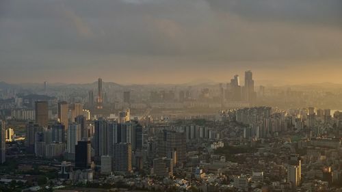 High angle view of modern buildings in city against sky