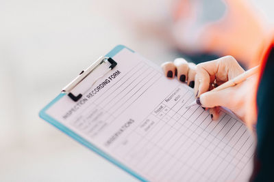 Cropped image of engineer writing in paper