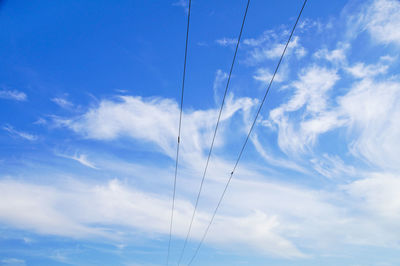 Low angle view of vapor trail against blue sky