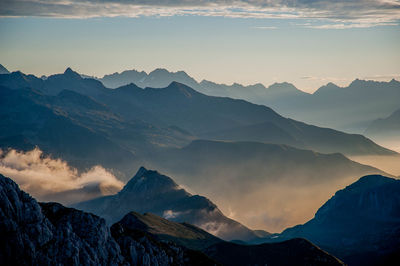 Scenic view of snowcapped mountains against sky during sunset