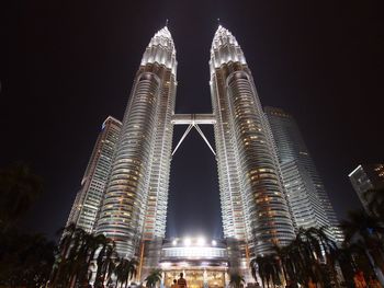 Low angle view of illuminated skyscraper against sky at night