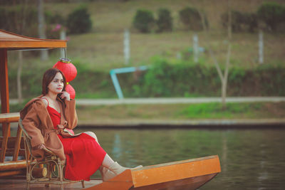 Asian woman wearing cheongsam traditional red dress on chinese new year travel.