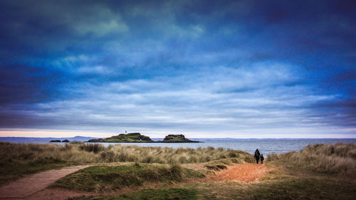 Scenic view of sea against cloudy sky