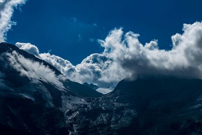 Scenic view of mountains against cloudy sky