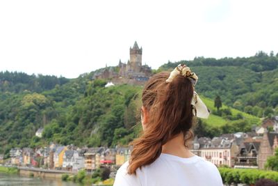 Rear view of woman looking at city buildings