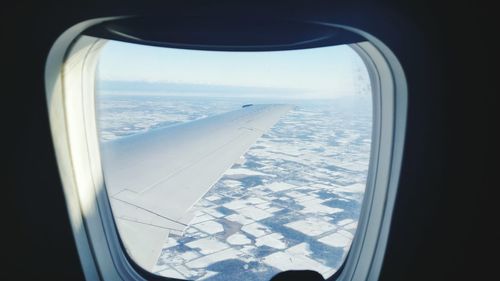 Aerial view of sea seen through airplane window