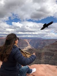 Woman looking at mountains against sky