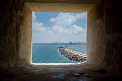 Scenic view of sea against sky seen through window