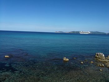 Scenic view of sea against clear blue sky