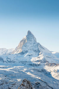 Scenic view of snowcapped mountains against clear sky