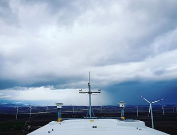 Wind turbines against sky