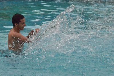 High angle view of boy playing in swimming pool