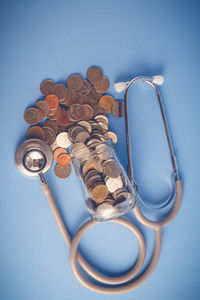 High angle view of eyeglasses on table against blue background