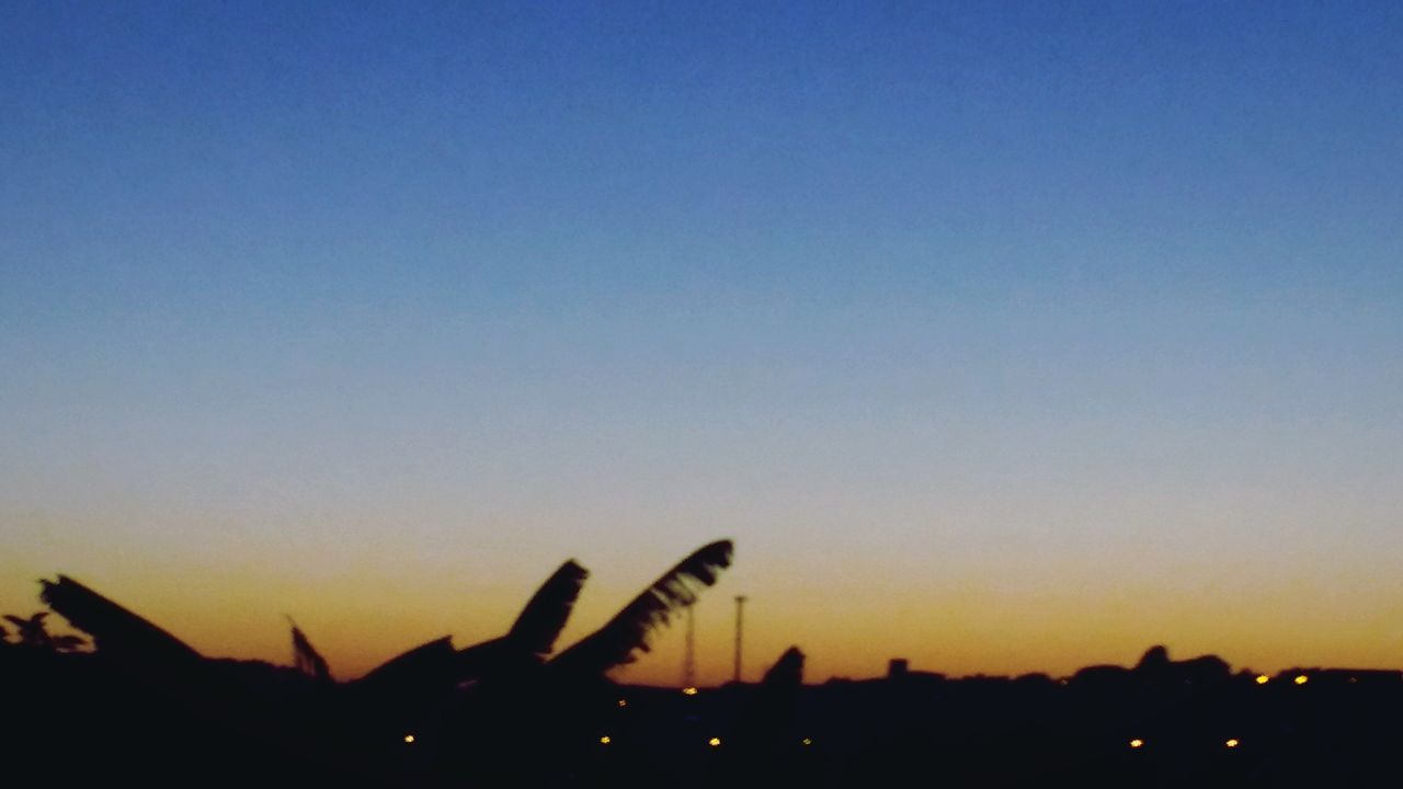 SILHOUETTE OF CITY AGAINST CLEAR SKY