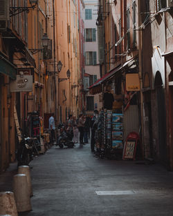 People on street amidst buildings in city