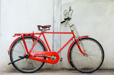 Bicycle parked against wall