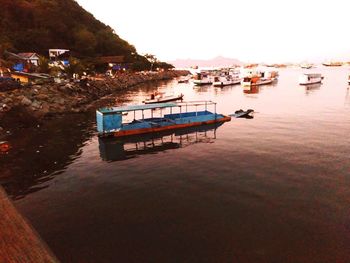 Boats moored on river against clear sky