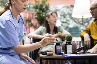 Midsection of woman using mobile phone