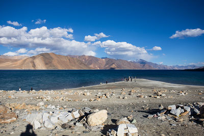 Scenic view of beach against blue sky