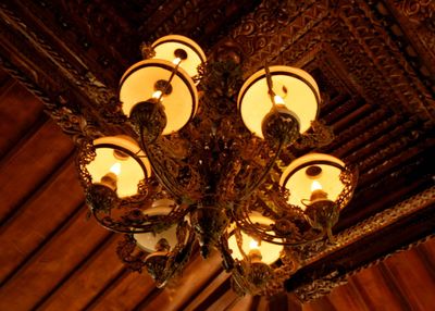 Low angle view of illuminated chandelier on table